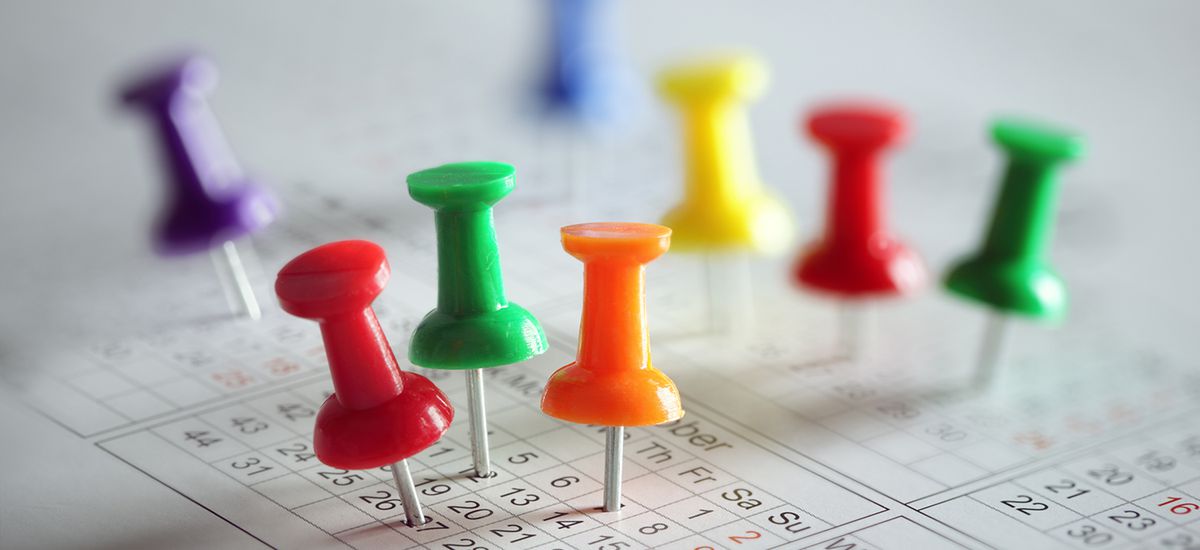 Thumbtack in calendar concept for busy, appointment and meeting reminder